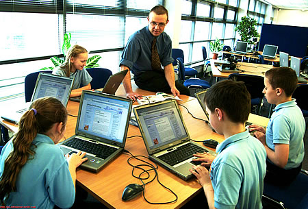 Teacher and students with technology.